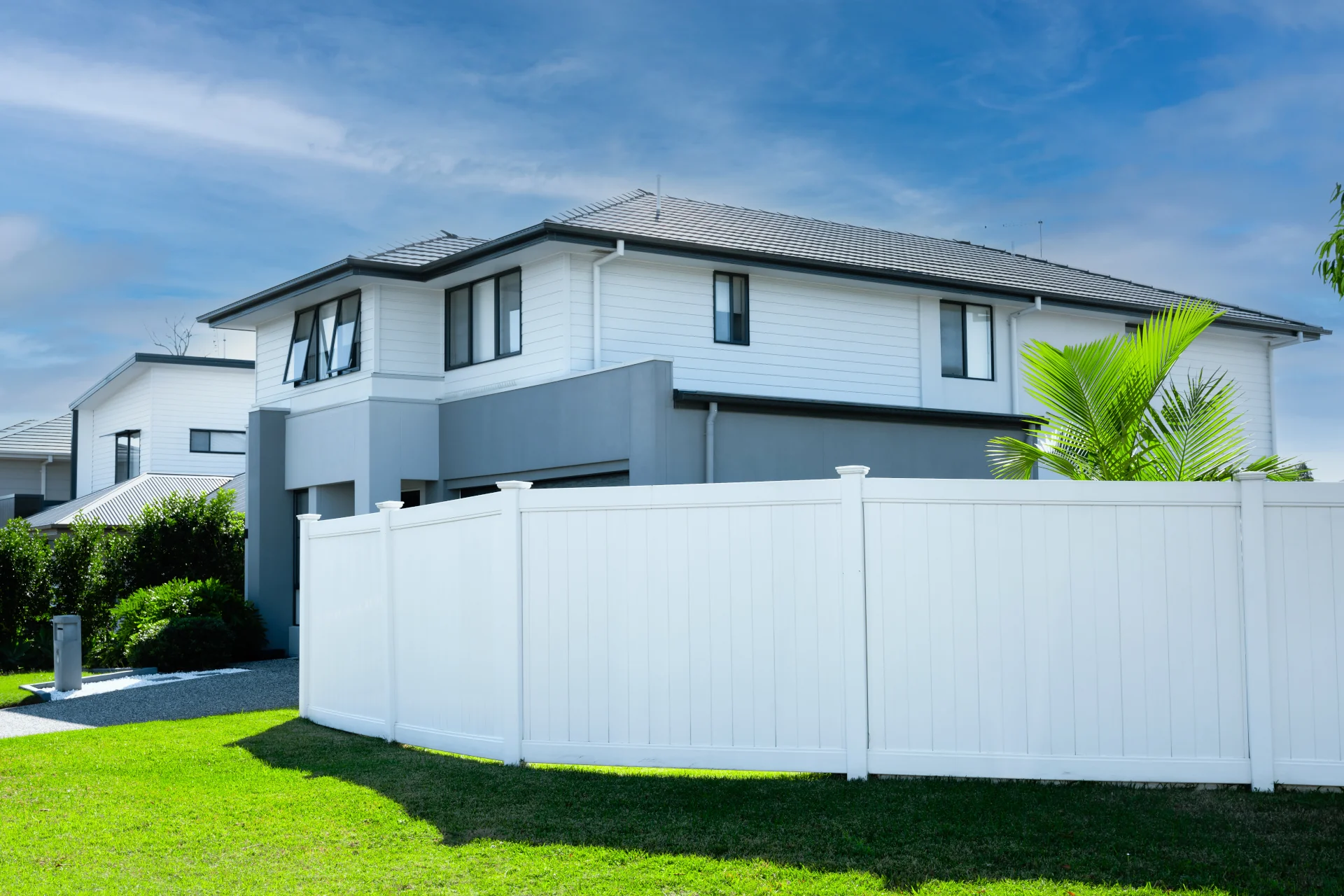 White PVC privacy fencing installed around a Queensland home